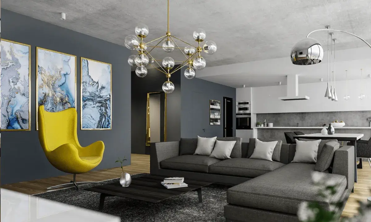 Nowoczesny salon z szarą sofą, żółtym fotelem i designerskim żyrandolem. Co to jest kinkiet? To lampa ścienna, której tu nie widać, ale jest ważnym elementem oświetlenia.