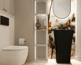 Nowoczesna, mała wąska toaleta z białym WC, czarną umywalką wolnostojącą i ozdobną ścianą.