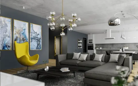 Nowoczesny salon z szarą sofą, żółtym fotelem i designerskim żyrandolem. Co to jest kinkiet? To lampa ścienna, której tu nie widać, ale jest ważnym elementem oświetlenia.