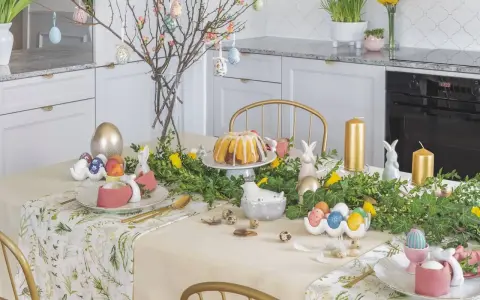 Stół wielkanocny inspiracje: złote pisanki, zajączki, babka i gałązki z ozdobami tworzą wiosenną atmosferę.