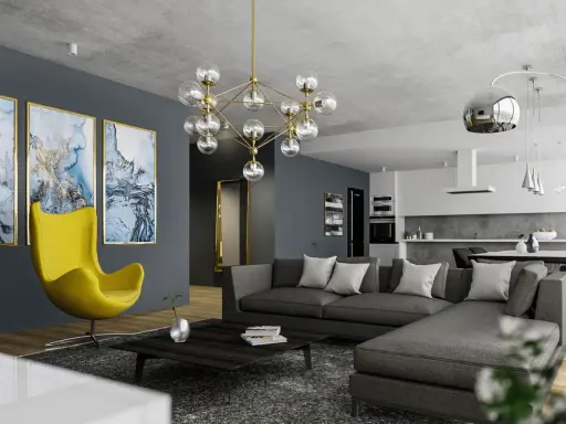Nowoczesny salon z szarą sofą, żółtym fotelem i designerskim żyrandolem. Co to jest kinkiet? To lampa ścienna, której tu nie widać, ale jest ważnym elementem oświetlenia.