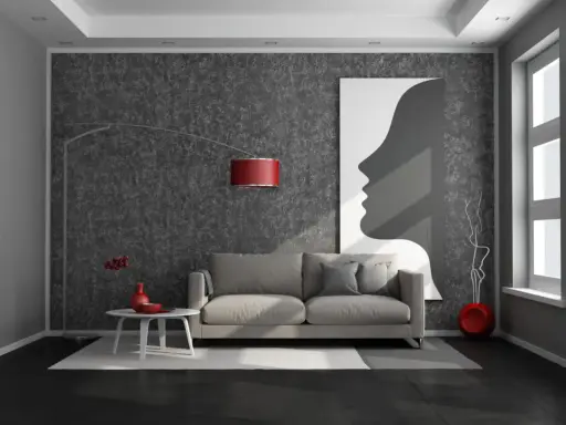 Nowoczesny salon z ciemną podłogą, szarą kanapą i abstrakcyjnym obrazem.