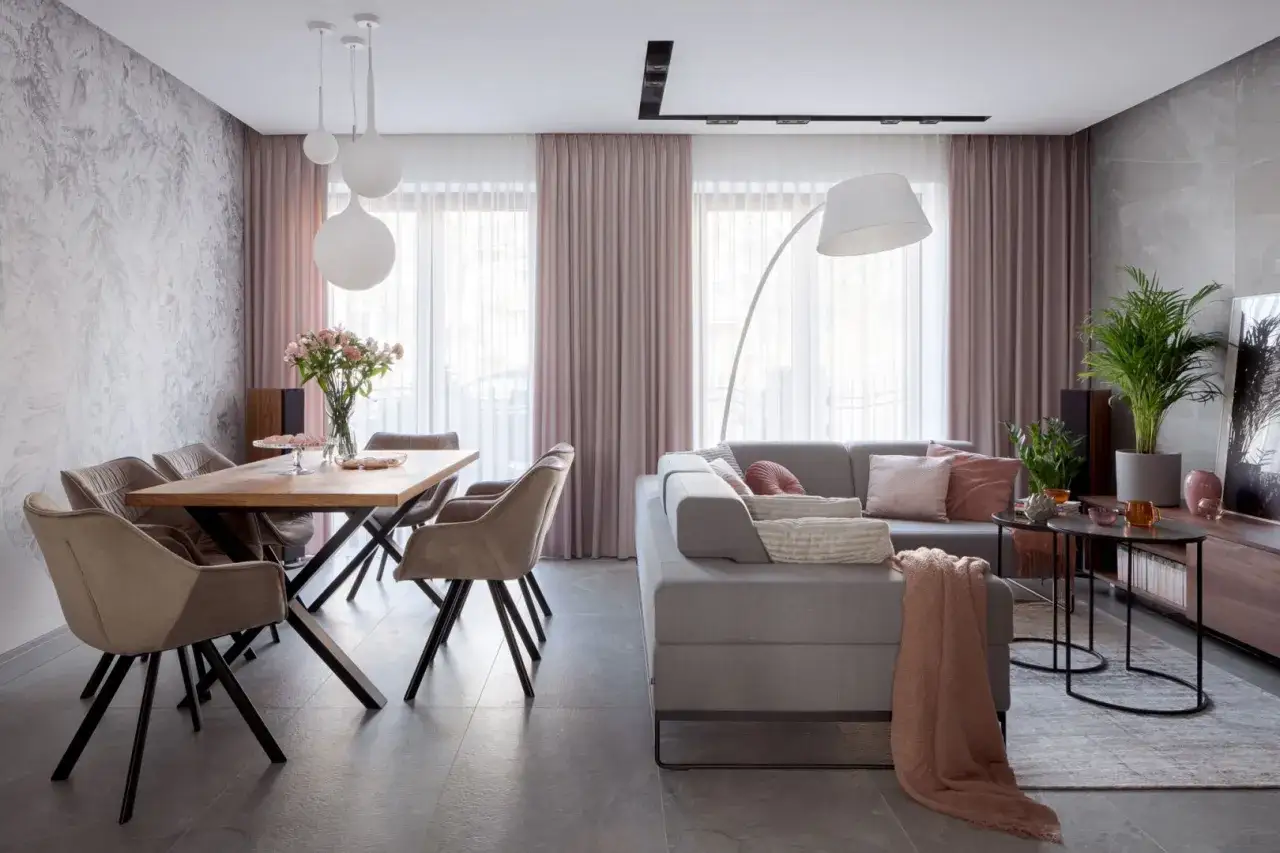 Salon inspiracje kolory: nowoczesny salon z jadalnią, szare meble, pudrowy róż i delikatne tekstury tworzą przytulną atmosferę.