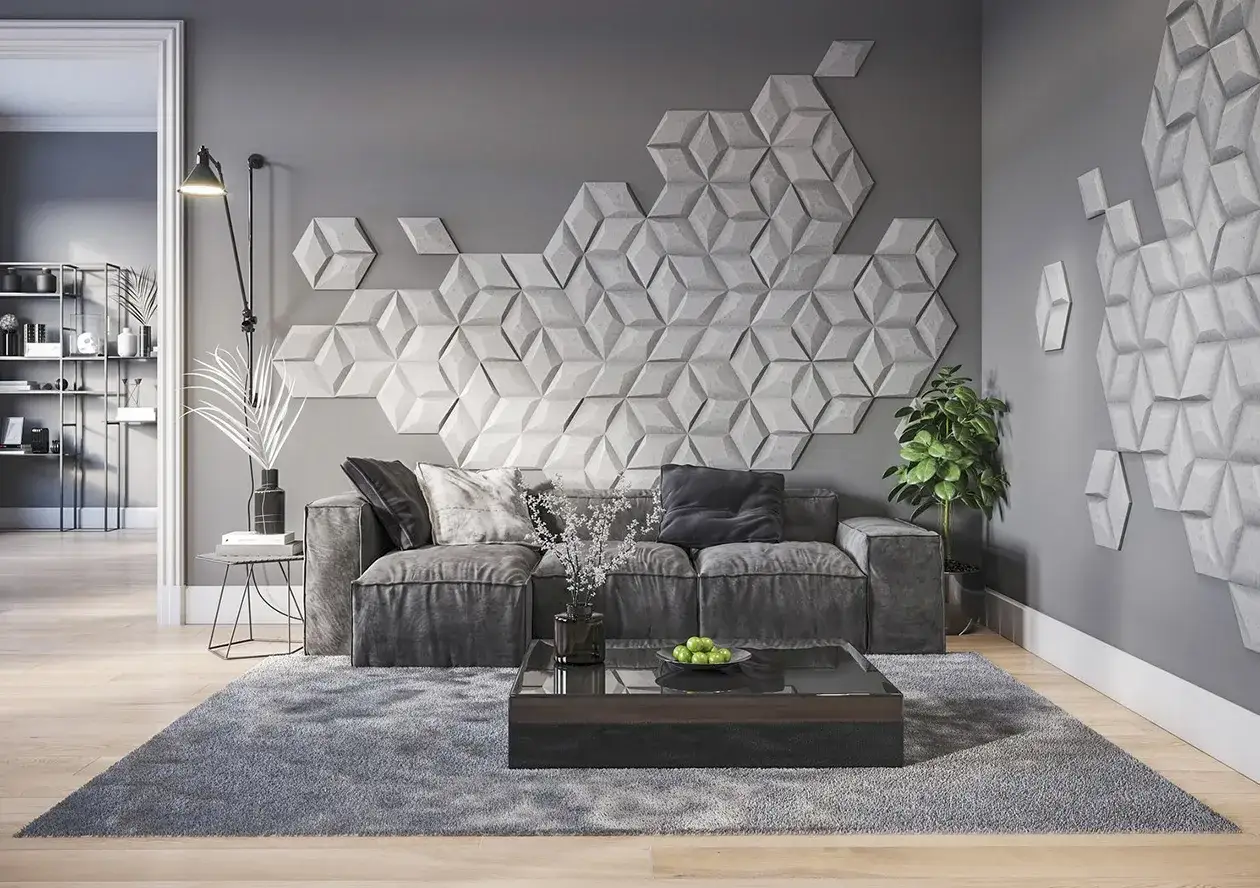 Nowoczesna ściana z geometrycznymi panelami 3D, świetna alternatywa co zamiast lameli. Szara kanapa, stolik kawowy i dywan tworzą przytulną przestrzeń.